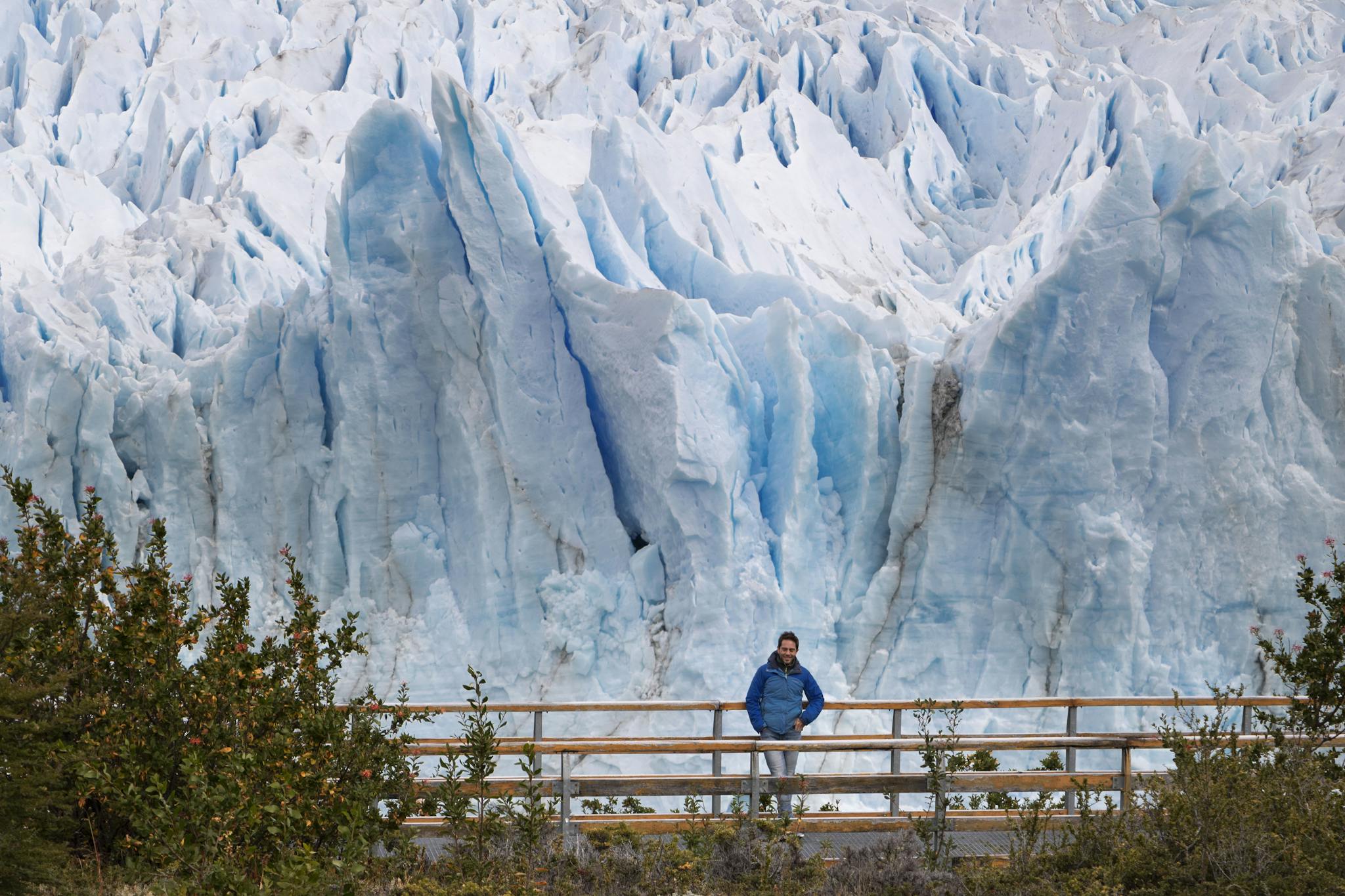 A tourist stands in front of the towering ice formations of Perito Moreno Glacier in Argentina.