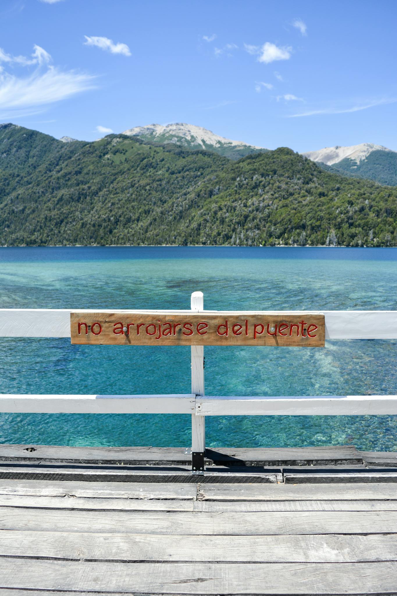 Beautiful view of Nahuel Huapi Lake with mountains and sign, in Villa La Angostura, Argentina.